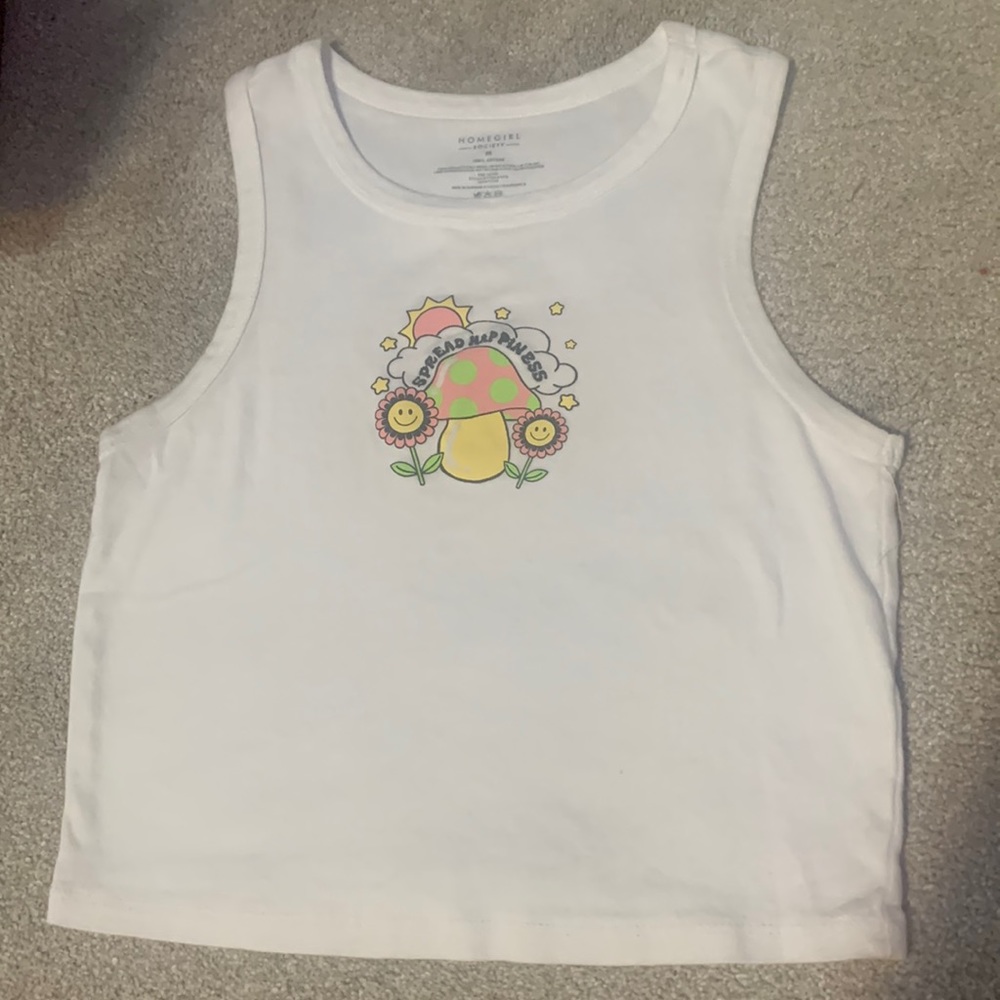 Pretty “spread happiness “ white top. There is barely any crop to this shirt.